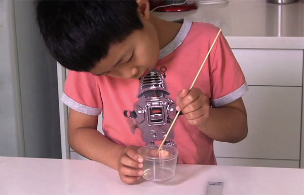 Child making droplet lens